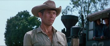 Movie still from “The Magnificent Seven” (1960), directed by John Sturges – A man wearing a cowboy hat standing in front of a bell; Close Up shot, Low angle
