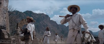 Movie still from “The Magnificent Seven” (1960), directed by John Sturges – A group of men in white clothes and hats; Wide shot, Low angle