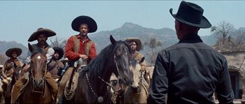 Movie still from “The Magnificent Seven” (1960), directed by John Sturges – A group of men on horses in a field; Medium shot, Low angle