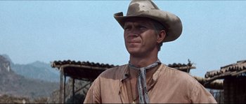 Movie still from “The Magnificent Seven” (1960), directed by John Sturges – A man wearing a cowboy hat standing in front of a building; Close Up shot, Low angle