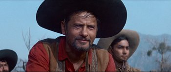 Movie still from “The Magnificent Seven” (1960), directed by John Sturges – A person wearing a cowboy hat; Close Up shot, Low angle