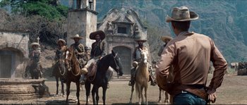 Movie still from “The Magnificent Seven” (1960), directed by John Sturges – A group of men on horses in a field; Wide shot, Low angle