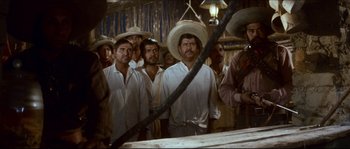 Movie still from “The Magnificent Seven” (1960), directed by John Sturges – A group of men wearing sombreros standing next to each other; Medium shot, Low angle