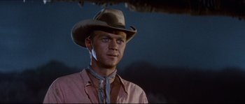 Movie still from “The Magnificent Seven” (1960), directed by John Sturges – A man wearing a cowboy hat and a pink shirt; Close Up shot, Low angle
