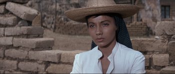 Movie still from “The Magnificent Seven” (1960), directed by John Sturges – A woman wearing a straw hat and a white shirt; Close Up shot, Low angle