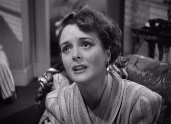 Movie still from “The Maltese Falcon” (1941), directed by John Huston – An older woman sitting on a couch looking sad; Close Up shot, High angle