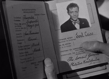 Movie still from “The Maltese Falcon” (1941), directed by John Huston – An old photo of a person holding a passport; Extreme Close Up shot, High angle
