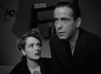 Movie still from “The Maltese Falcon” (1941), directed by John Huston – A man and a woman are looking at the camera; Close Up shot, Low angle