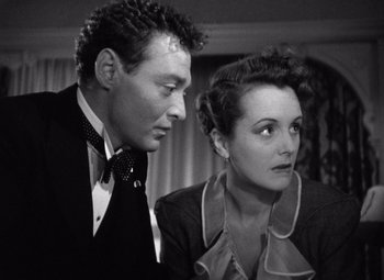 Movie still from “The Maltese Falcon” (1941), directed by John Huston – A man and a woman looking at one another; Close Up shot, High angle