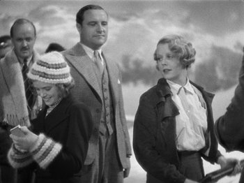 Movie still from “The Man Who Knew Too Much” (1934), directed by Alfred Hitchcock – A man and a woman standing next to each other; Medium shot, Low angle