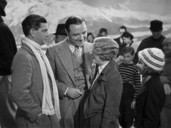 Movie still from “The Man Who Knew Too Much” (1934), directed by Alfred Hitchcock – A group of men standing next to each other on a field; Medium shot, High angle