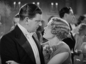 Movie still from “The Man Who Knew Too Much” (1934), directed by Alfred Hitchcock – An older man and a woman in formal wear; Medium shot, Low angle