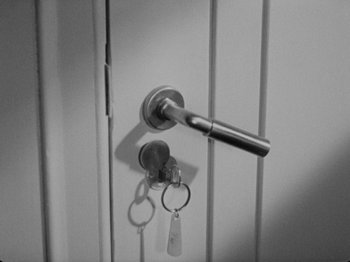 Movie still from “The Man Who Knew Too Much” (1934), directed by Alfred Hitchcock – A bunch of keys hanging on the side of a door; Extreme Close Up shot, High angle