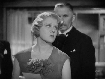 Movie still from “The Man Who Knew Too Much” (1934), directed by Alfred Hitchcock – An old photo of a man and a woman; Close Up shot, Low angle