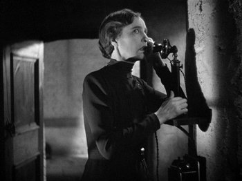 Movie still from “The Man Who Knew Too Much” (1934), directed by Alfred Hitchcock – An old photo of a woman talking on a phone; Close Up shot, High angle