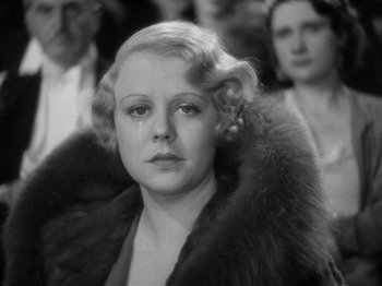 Movie still from “The Man Who Knew Too Much” (1934), directed by Alfred Hitchcock – An old black and white photo of a woman in fur; Close Up shot, Low angle