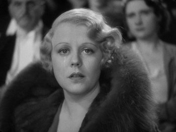 Movie still from “The Man Who Knew Too Much” (1934), directed by Alfred Hitchcock – An old black and white photo of a woman in fur; Close Up shot, Low angle
