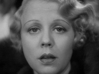Movie still from “The Man Who Knew Too Much” (1934), directed by Alfred Hitchcock – An old black and white photo of a woman's face; Close Up shot, High angle