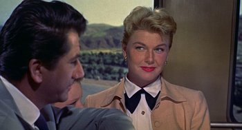 Movie still from “The Man Who Knew Too Much” (1956), directed by Alfred Hitchcock – A man and a woman are talking to each other; Close Up shot, Over the shoulder angle