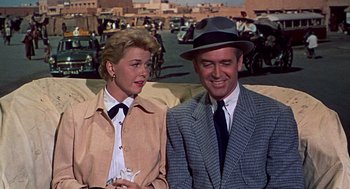 Movie still from “The Man Who Knew Too Much” (1956), directed by Alfred Hitchcock – A man and a woman sitting next to each other; Medium shot, Low angle