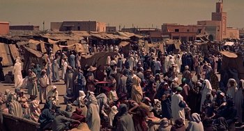 Movie still from “The Man Who Knew Too Much” (1956), directed by Alfred Hitchcock – A large group of people gathered in the middle of the street; Extreme Wide shot, High angle