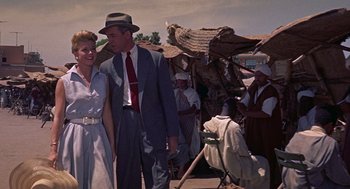 Movie still from “The Man Who Knew Too Much” (1956), directed by Alfred Hitchcock – A man and a woman standing next to each other; Medium shot, Low angle