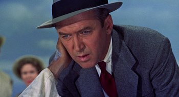 Movie still from “The Man Who Knew Too Much” (1956), directed by Alfred Hitchcock – An older man in a hat and a suit and tie; Close Up shot, Low angle