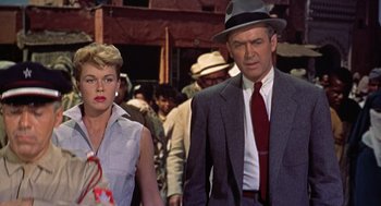 Movie still from “The Man Who Knew Too Much” (1956), directed by Alfred Hitchcock – A man and a woman walking in a crowd of people; Medium shot, Low angle