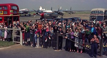Movie still from “The Man Who Knew Too Much” (1956), directed by Alfred Hitchcock – A group of people standing next to each other on a runway; Extreme Wide shot, High angle