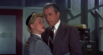 Movie still from “The Man Who Knew Too Much” (1956), directed by Alfred Hitchcock – An older man and a younger woman hugging; Medium shot, Low angle