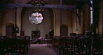 Movie still from “The Man Who Knew Too Much” (1956), directed by Alfred Hitchcock – A person is laying on the ground in a church; Extreme Wide shot, High angle