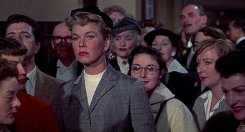 Movie still from “The Man Who Knew Too Much” (1956), directed by Alfred Hitchcock – A group of people standing in front of each other; Medium shot, Low angle