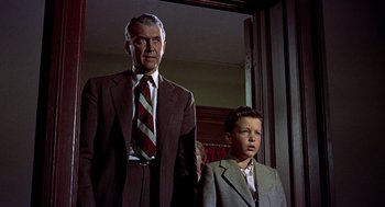Movie still from “The Man Who Knew Too Much” (1956), directed by Alfred Hitchcock – An older man and a young boy standing next to each other; Medium shot, Low angle