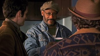 Movie still from “The Man from Earth” (2007), directed by Richard Schenkman – A group of men standing around a kitchen; Close Up shot, Over the shoulder angle