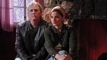 Movie still from “The Man from Earth” (2007), directed by Richard Schenkman – A man and a woman sitting next to each other; Medium shot, Low angle