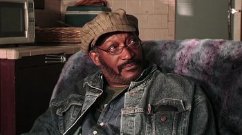 Movie still from “The Man from Earth” (2007), directed by Richard Schenkman – An older man wearing a jean jacket and a hat; Close Up shot, Low angle