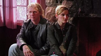 Movie still from “The Man from Earth” (2007), directed by Richard Schenkman – A man and a woman sitting next to each other; Medium shot, Over the shoulder angle