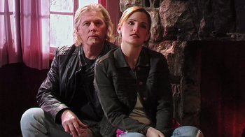 Movie still from “The Man from Earth” (2007), directed by Richard Schenkman – A man and a woman sitting next to each other on a couch; Medium shot, Low angle