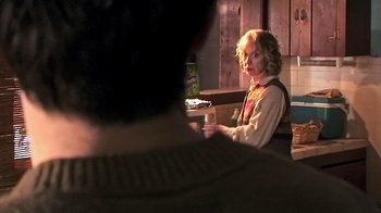 Movie still from “The Man from Earth” (2007), directed by Richard Schenkman – A woman sitting at a table in front of a man; Medium shot, Over the shoulder angle