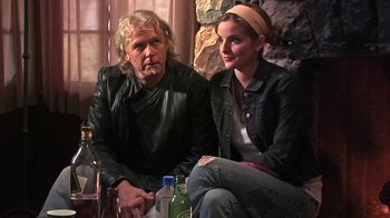 Movie still from “The Man from Earth” (2007), directed by Richard Schenkman – A man and a woman sitting next to each other; Medium shot, Low angle