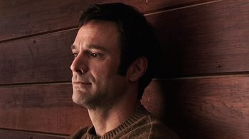 Movie still from “The Man from Earth” (2007), directed by Richard Schenkman – A person wearing a sweater; Close Up shot, Low angle