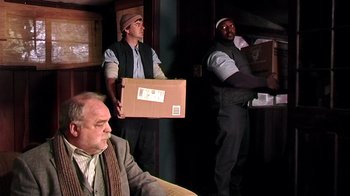 Movie still from “The Man from Earth” (2007), directed by Richard Schenkman – A group of men standing next to each other holding boxes; Medium shot, Low angle