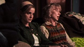 Movie still from “The Man from Earth” (2007), directed by Richard Schenkman – Two women sitting next to each other on a couch; Medium shot, Over the shoulder angle