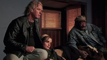 Movie still from “The Man from Earth” (2007), directed by Richard Schenkman – A man and a woman sitting next to each other on a couch; Medium shot, Low angle