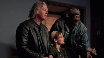 Movie still from “The Man from Earth” (2007), directed by Richard Schenkman – A group of people standing next to each other on a stage; Medium shot, Low angle