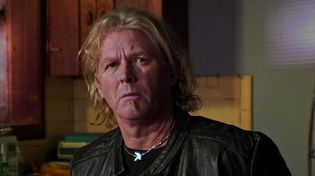 Movie still from “The Man from Earth” (2007), directed by Richard Schenkman – A person wearing a leather jacket; Close Up shot, Low angle