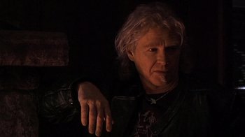 Movie still from “The Man from Earth” (2007), directed by Richard Schenkman – A man in a leather jacket is smoking a cigarette; Close Up shot, Low angle