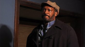 Movie still from “The Man from Earth” (2007), directed by Richard Schenkman – A man wearing a hat and a coat; Close Up shot, Low angle