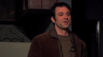 Movie still from “The Man from Earth” (2007), directed by Richard Schenkman – A man wearing a brown jacket and a brown sweater; Close Up shot, Low angle