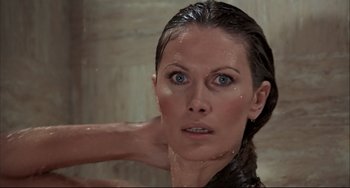 Movie still from “The Man with the Golden Gun” (1974), directed by Guy Hamilton – A woman with wet hair and blue eyes in the shower; Close Up shot, Low angle